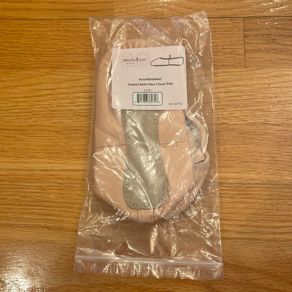 Brand new pink ballet shoes size 13.5 for kids. Never been out of the bag.